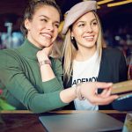 two-women-using-credit-at-bar.jpg