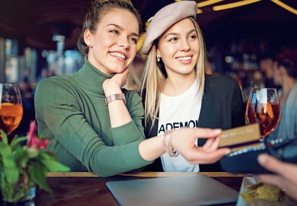 two-women-using-credit-at-bar.jpg
