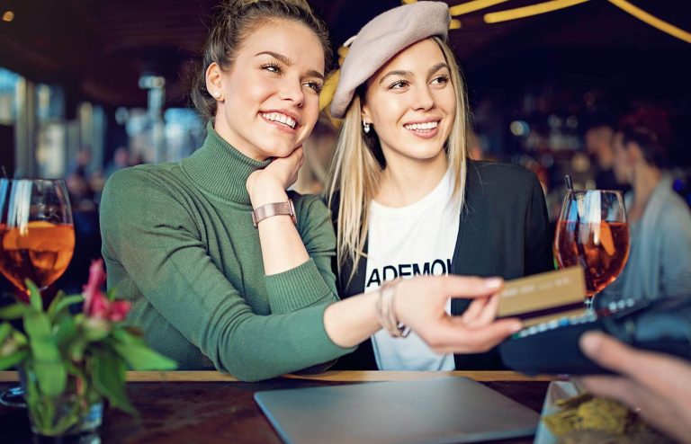 two-women-using-credit-at-bar.jpg